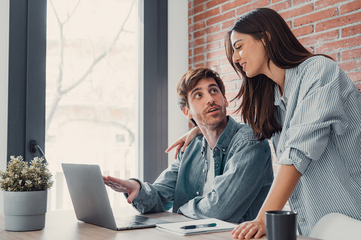 Two people are sitting at a table, developing a smart website in our ia web agency